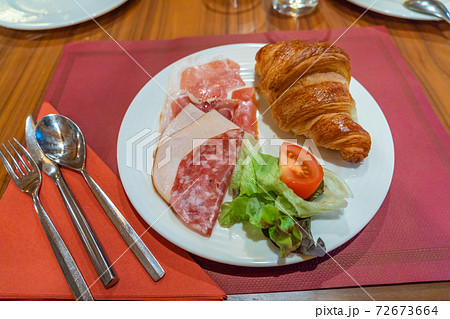 Breakfast meal with ham croissant and vegetables in hotel Breakfast meal with ham croissant and vegetables in hotel 72673664