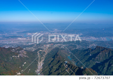 Aerial view of mountain landscape under clear blue sky Aerial view of mountain landscape under clear blue sky 72673707