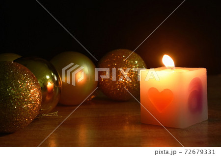 golden ball couple candle light for decoration in Christmas and new year festival in black background golden ball couple candle light for decoration in Christmas and new year festival in black background 72679331