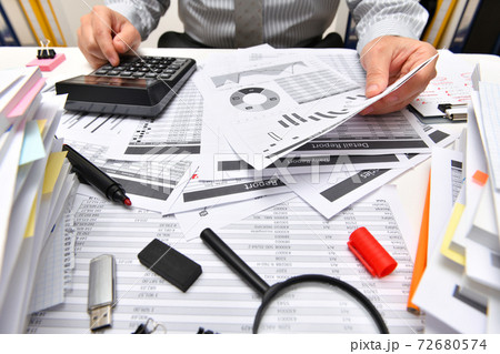 business concept - businessman working with reports in office, table and workspace close view, analyzing financial data, writes and counts 72680574