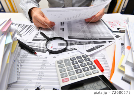 business concept - businessman working with reports in office, table and workspace close view, analyzing financial data, writes and counts 72680575