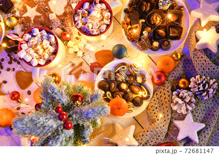 sweet food top view background for merry christmas or new year holiday decoration with night illumination - chocolate candies, tangerines, cookies, marshmallow and cocoa latte on white wood sweet food top view background for merry christmas or new year holiday decoration with night illumination - chocolate candies, tangerines, cookies, marshmallow and cocoa latte on white wood 72681147