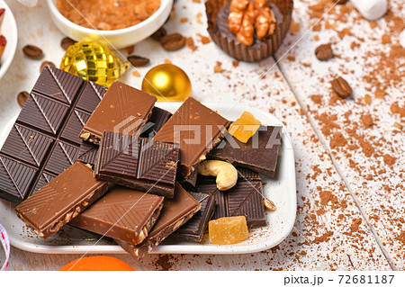 sweet food top view background for merry christmas or new year holiday decoration - chocolate candies, tangerines, cookies on white wood 72681187