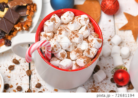 sweet food top view background for merry christmas or new year holiday decoration - chocolate candies, tangerines, cookies, marshmallow and cocoa latte on white wood 72681194
