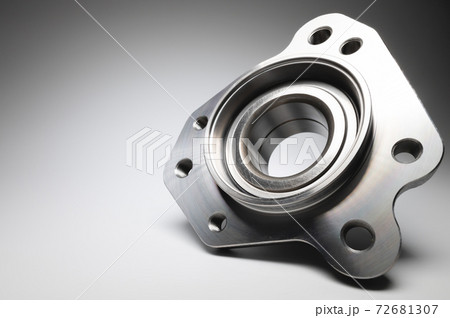 New wheel bearing in a metal housing on a black-white gradient background. New car suspension parts 72681307