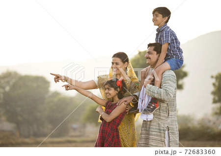 Happy rural Indian family on agricultural field Happy rural Indian family on agricultural field 72683360