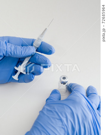 Hands Holding Syringe and Vial Hands Holding Syringe and Vial 72685964