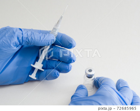 Hands Holding Syringe and Vial Hands Holding Syringe and Vial 72685965