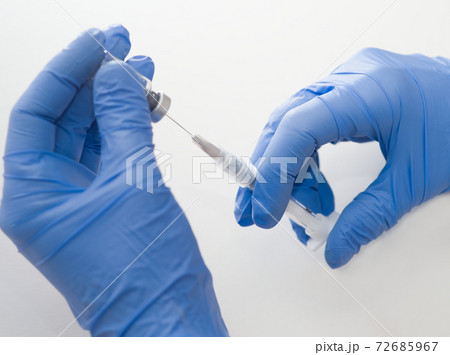 Hands Holding Syringe and Vial Hands Holding Syringe and Vial 72685967