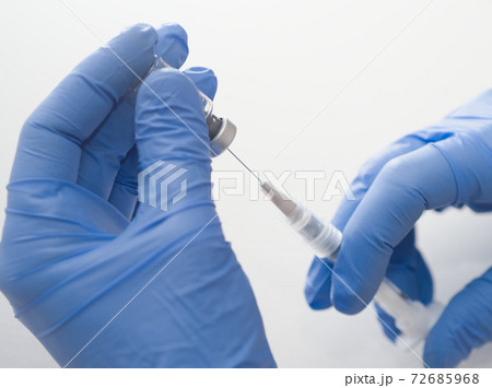 Hands Holding Syringe and Vial Hands Holding Syringe and Vial 72685968