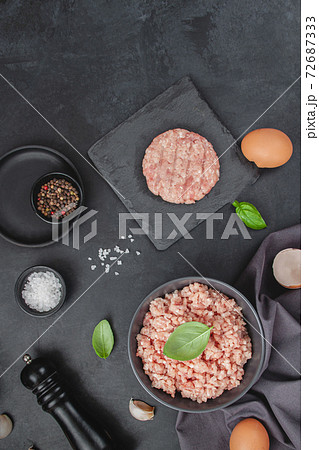 Raw minced meat in bowl on wooden table Raw minced meat in bowl on wooden table 72687333