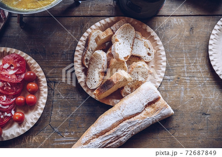 Sliced baguette on the wooden table Sliced baguette on the wooden table 72687849