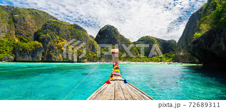 Traditional wooden boat in a picture perfect tropical bay on Koh Phi Phi Island, Thailand, Asia Traditional wooden boat in a picture perfect tropical bay on Koh Phi Phi Island, Thailand, Asia 72689311