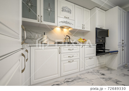 White kitchen in classic style, front view 72689330