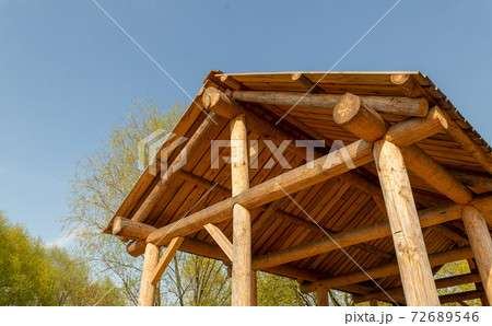 roof of a wooden barn built on a classical structure against a blue sky roof of a wooden barn built on a classical structure against a blue sky 72689546