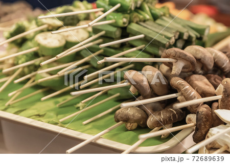 assorted vegetables and mushroom skewers on a wooden skewer asian market selective focus 72689639