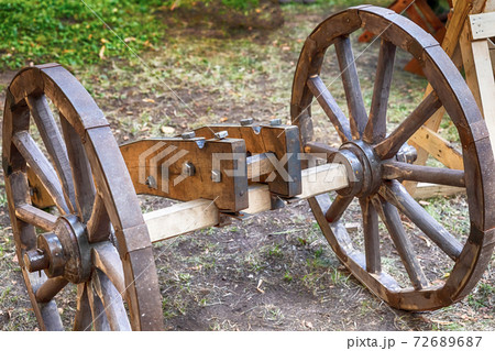 old wooden base for a cannon with large wheels 72689687