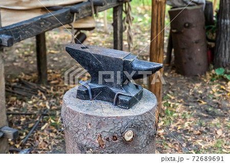 iron black anvil on the stump piece of forge equipment iron black anvil on the stump piece of forge equipment 72689691
