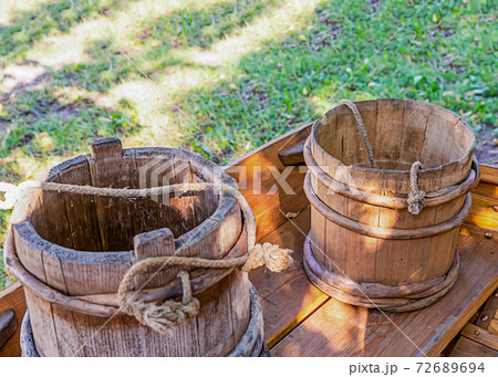 pair of wooden water buckets stand on a table pair of wooden water buckets stand on a table 72689694