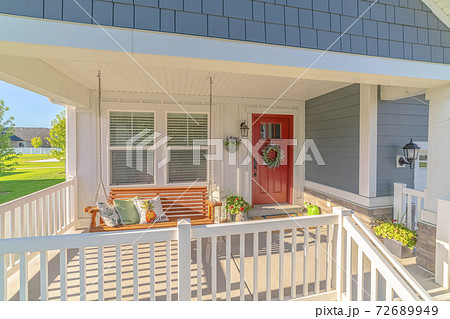 Front porch of traditional home and swinging chair Front porch of traditional home and swinging chair 72689949