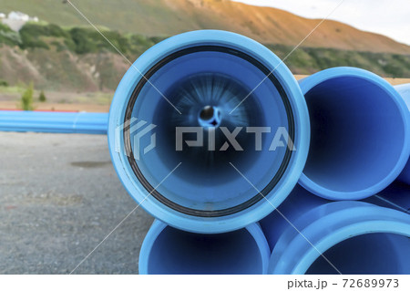 Close up of the holes of light blue pipes at a construction area on a sunny day 72689973