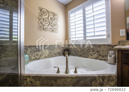 Bathroom interior with built in bathtub adjacent to the shower stall and vanity Bathroom interior with built in bathtub adjacent to the shower stall and vanity 72690032