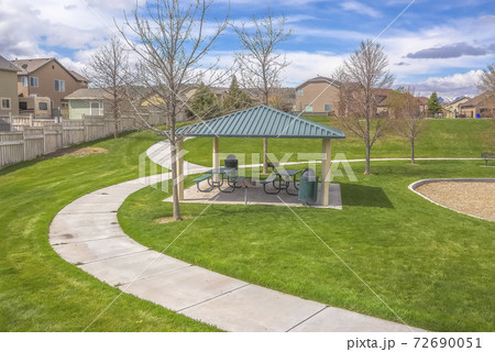 Small picnic area and curving pathways on a park covered with vivid grasses Small picnic area and curving pathways on a park covered with vivid grasses 72690051