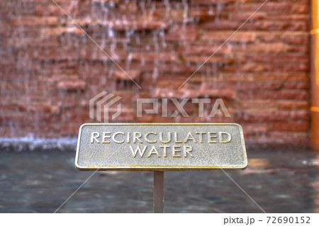 Close up of metal plate with words Recirculated Water embossed on surface Close up of metal plate with words Recirculated Water embossed on surface 72690152
