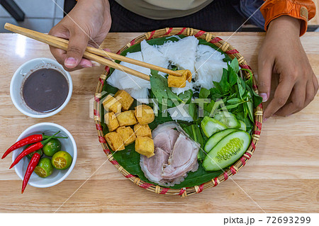 Woman eating Vietnamese ethnic cuisine Bun Dau Mam Tom Woman eating Vietnamese ethnic cuisine Bun Dau Mam Tom 72693299