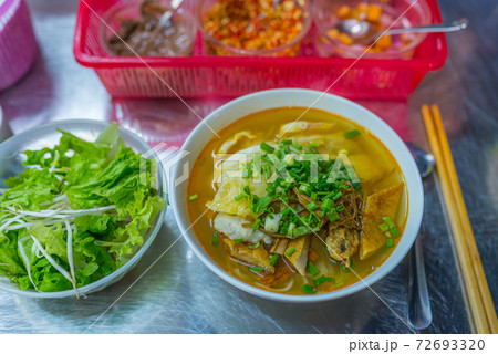 Bowl of delicious fish noodles soup served with vegetables Bowl of delicious fish noodles soup served with vegetables 72693320