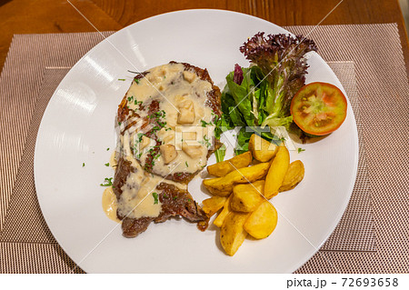 Close up photo of beef steak and creamy mushroom sauce  72693658