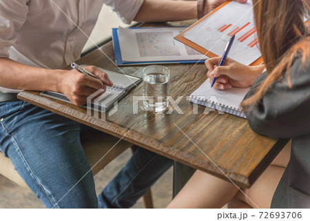 Close up of human hands writing on notebook 72693706