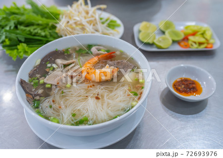 Bowl of famous Vietnamese rice noodle served with vegetables Bowl of famous Vietnamese rice noodle served with vegetables 72693976