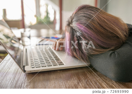 Young girl feel tired, frustrated and sleeping on laptop 72693990