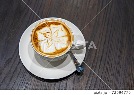 Overhead view photo of latte art milk foam cappuccino coffee Overhead view photo of latte art milk foam cappuccino coffee 72694779