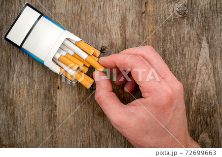 Close-up view of male hand take a cigarette 72699663