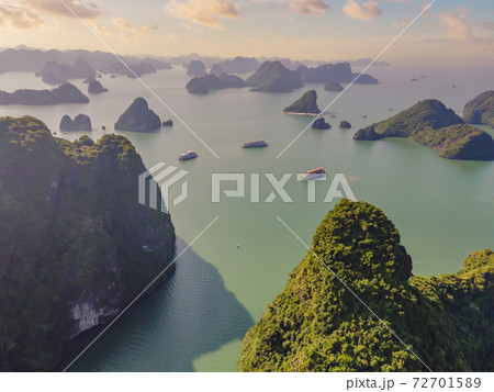 Aerial view panorama of floating fishing village and rock island, Halong Bay, Vietnam, Southeast Asia. UNESCO World Heritage Site. Junk boat cruise to Ha Long Bay. Popular landmark of Vietnam Aerial view panorama of floating fishing village and rock island, Halong Bay, Vietnam, Southeast Asia. UNESCO World Heritage Site. Junk boat cruise to Ha Long Bay. Popular landmark of Vietnam 72701589
