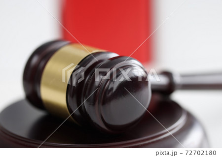 Wooden gavel for judge and auctions lies on stand 72702180
