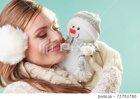 Smiling cute woman with little snowman. Winter. Smiling cute woman with little snowman. Winter. 72703780