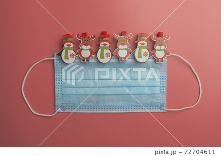 medical face mask Christmas toys with a pink background. the view from the top 72704611