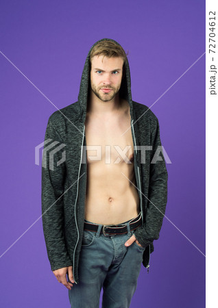 Man with bare torso wearing hoodie. Hipster with trimmed stylish beard 72704612