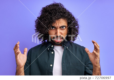 angry male is tired of enduring such behavior, looks at camera irritated angry male is tired of enduring such behavior, looks at camera irritated 72706997