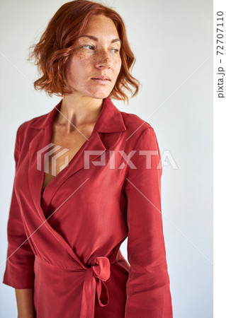 pensive redhead lady in dress isolated pensive redhead lady in dress isolated 72707110