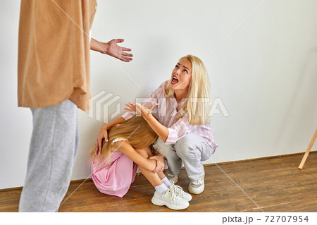 blond woman and child girl sits suffering from cruelty of father blond woman and child girl sits suffering from cruelty of father 72707954