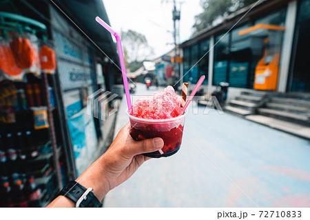 Shaved ice in a cup during the day 72710833