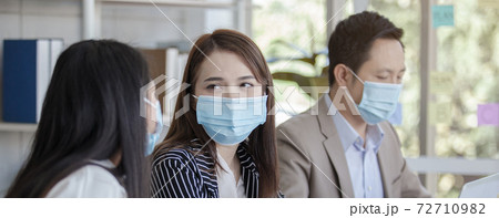 Business people wearing medical mask protect against airborne disease. Business people wearing medical mask protect against airborne disease. 72710982