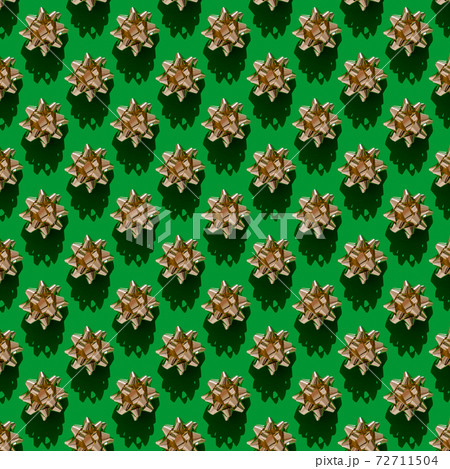 Seamless background of golden present ribbon on green Seamless background of golden present ribbon on green 72711504