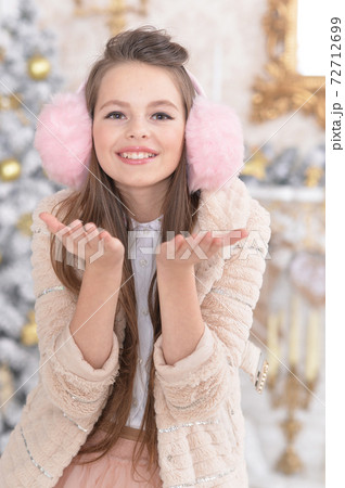 Portrait of beautiful girl posig hear Christmas tree at home Portrait of beautiful girl posig hear Christmas tree at home 72712699