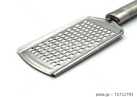 Closeup of metallic grater on white background 72712795