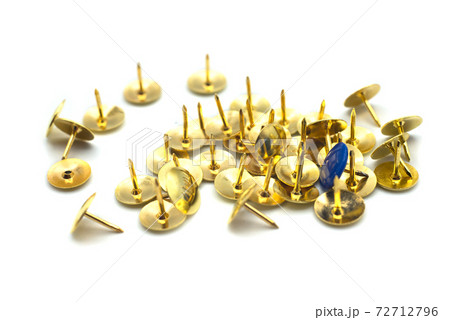 Closeup of golden paper pins on white background 72712796